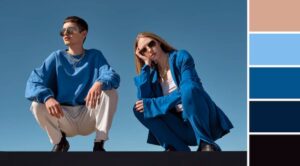 Two individuals in coordinated blue outfits pose against a clear sky, showcasing their trendy styles alongside a color palette.